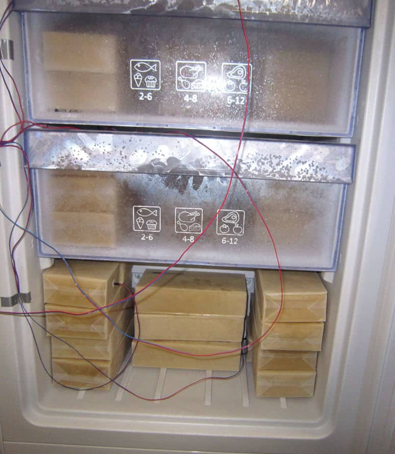 Elintarvikkeita simuloivia pakkauksia ja lämpömittareita pakastimessa.