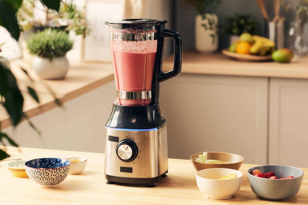 Tehosekoitin, jossa on punaista smoothieta.