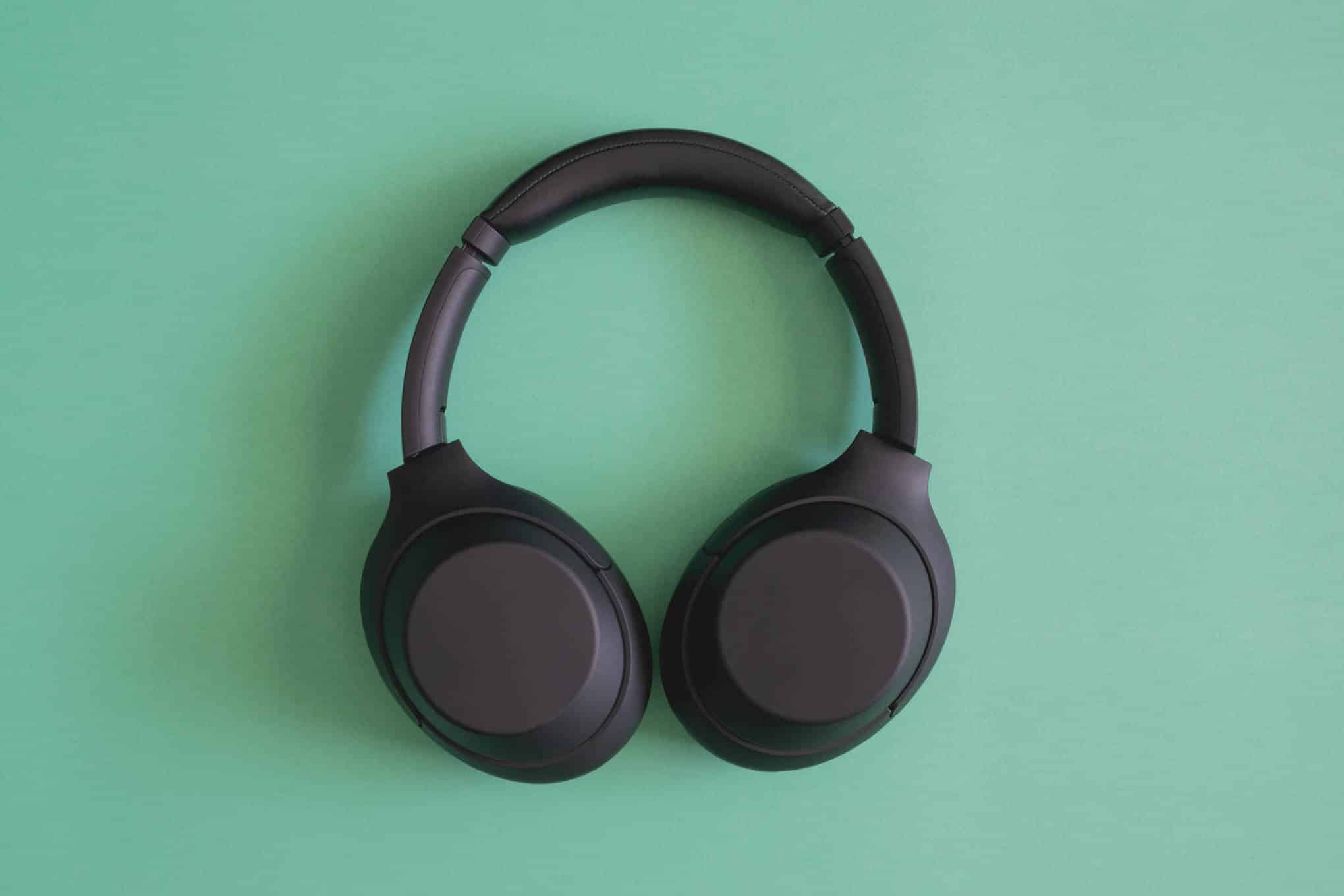 Mustat sankakuulokkeet vihreällä taustalla.