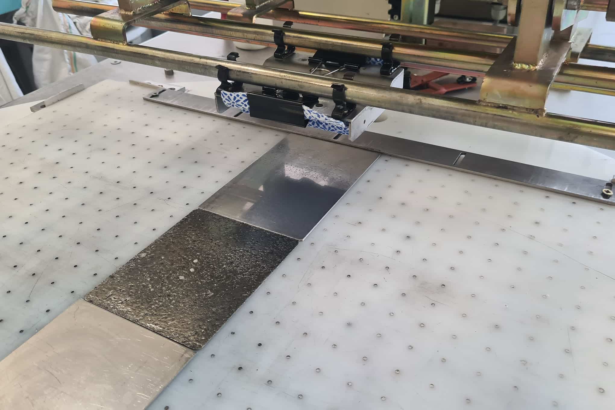 Testauslaite ja eri materiaaleista valmistettuja paloja.