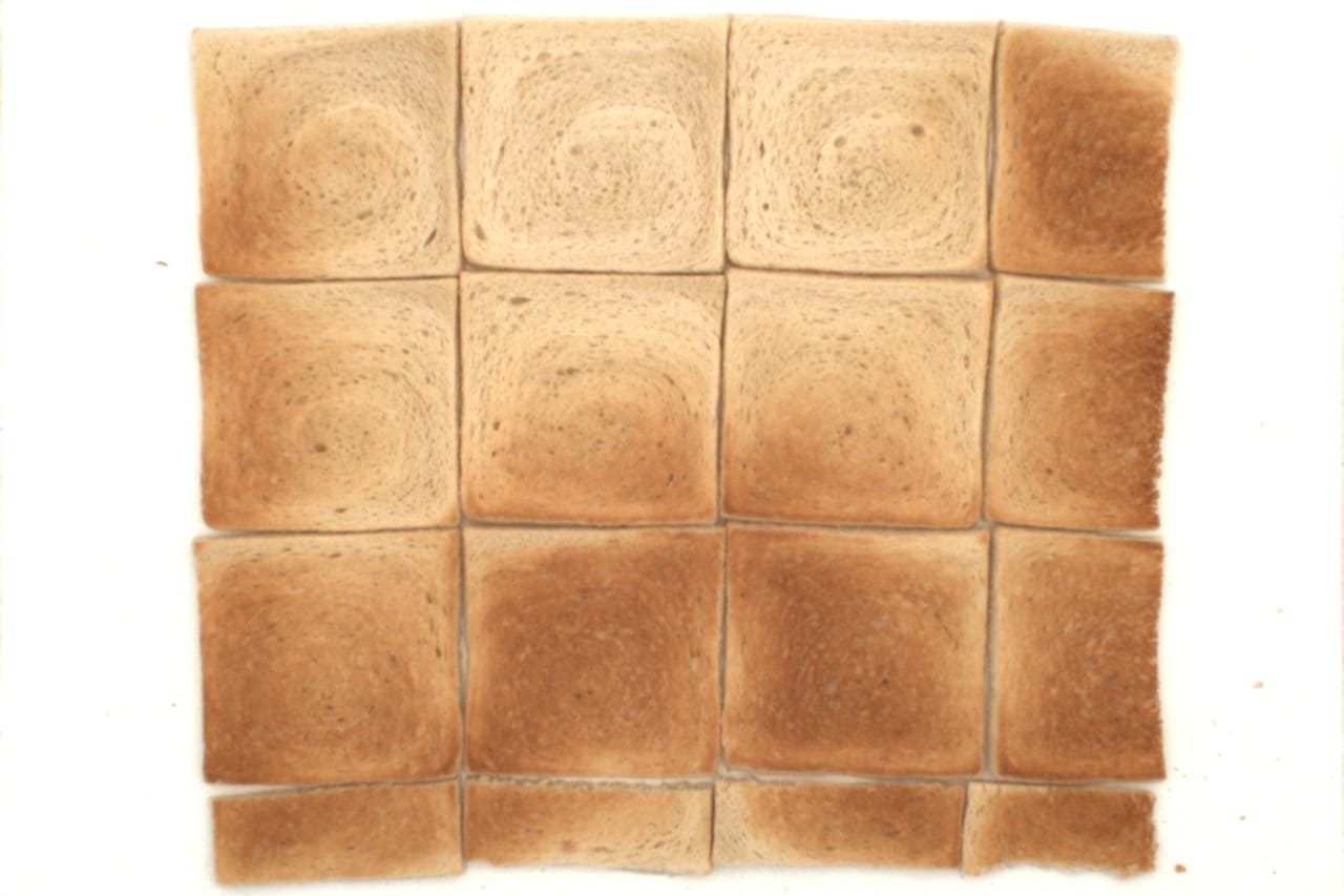 16 paahtoleipää, jotka on asetettu vieri viereen, neliön muotoiseen asetelmaan.